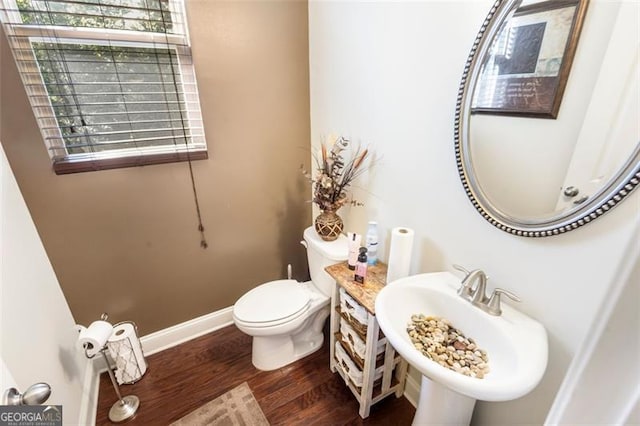 bathroom featuring hardwood / wood-style flooring, toilet, a healthy amount of sunlight, and sink