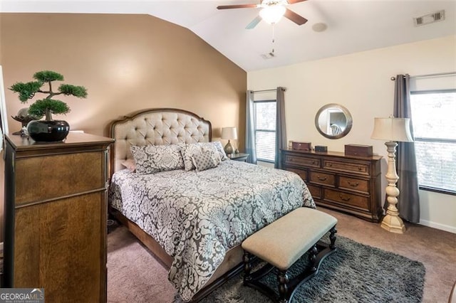 carpeted bedroom with ceiling fan and vaulted ceiling