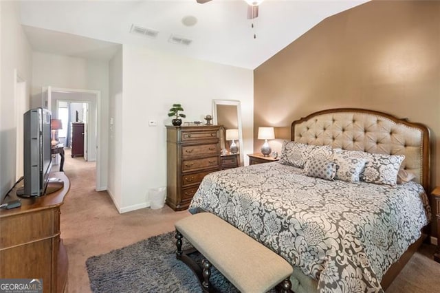 bedroom with ceiling fan, light carpet, and vaulted ceiling