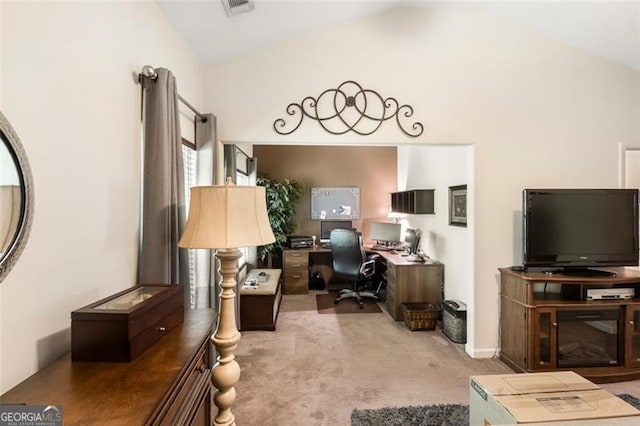 carpeted office space featuring lofted ceiling