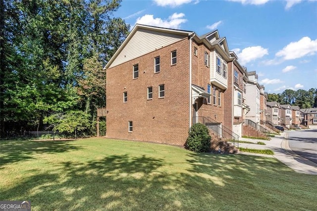 view of side of home featuring a lawn