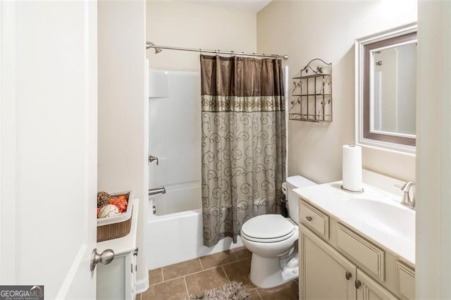 full bathroom with tile patterned floors, shower / bath combo with shower curtain, vanity, and toilet