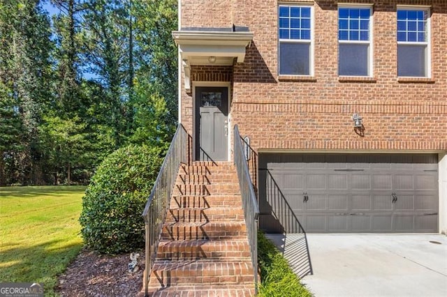 doorway to property with a lawn and a garage