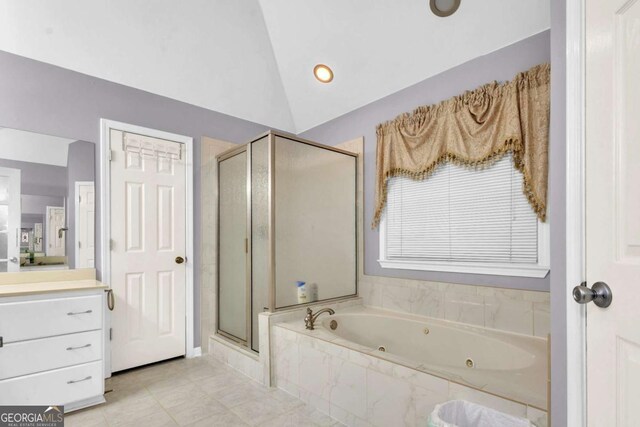 bathroom featuring tile patterned flooring, vanity, separate shower and tub, and lofted ceiling