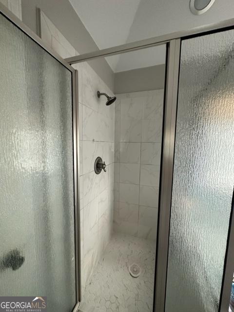 bathroom with a shower with shower door