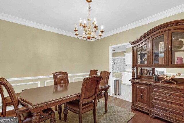 dining space featuring ornamental molding and an inviting chandelier