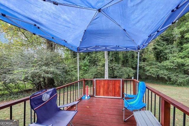 wooden terrace featuring a yard