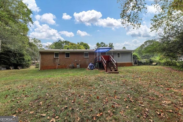 rear view of house with a yard