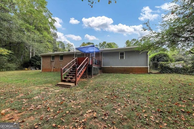 rear view of house with a lawn