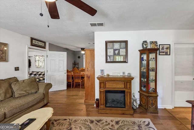 living room with hardwood / wood-style floors and a textured ceiling