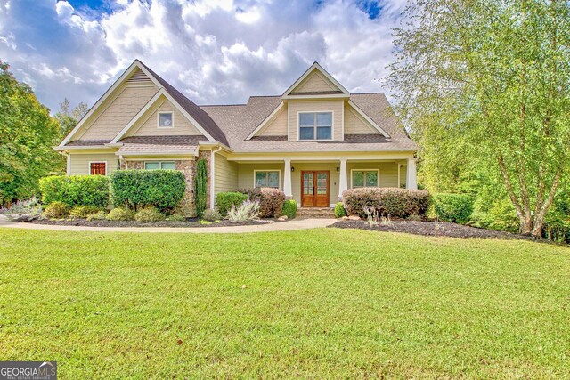 craftsman-style house with french doors and a front lawn