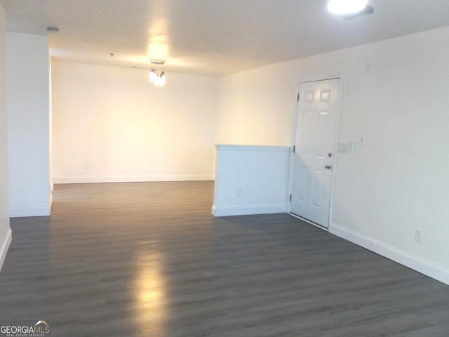 empty room with dark hardwood / wood-style floors