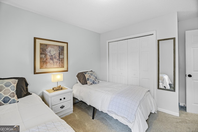 bedroom featuring light colored carpet and a closet