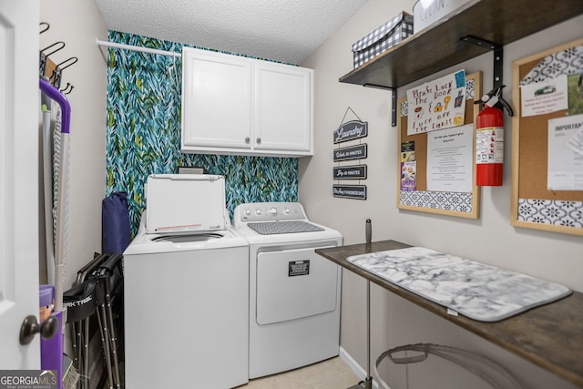 washroom featuring cabinets, independent washer and dryer, a textured ceiling, and light tile patterned floors