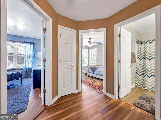 corridor with hardwood / wood-style floors