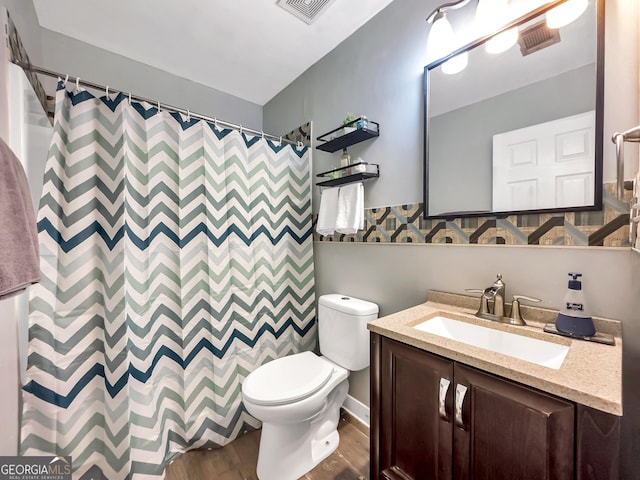 bathroom with wood-type flooring, vanity, toilet, and a shower with curtain