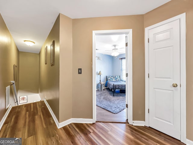 hall with wood-type flooring