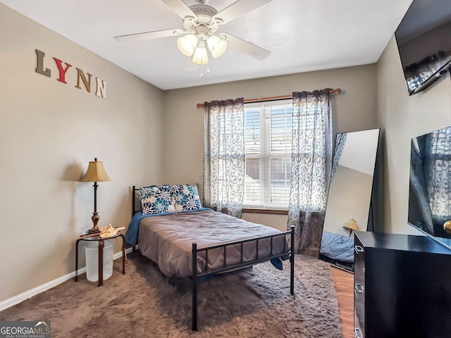 bedroom with multiple windows and ceiling fan