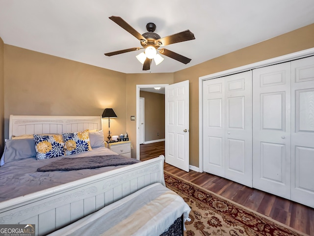 bedroom featuring ceiling fan, a closet, and dark wood-type flooring