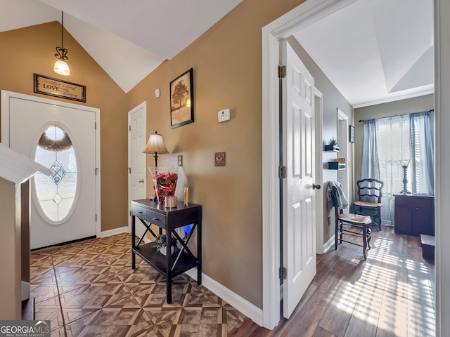 foyer featuring vaulted ceiling and parquet flooring