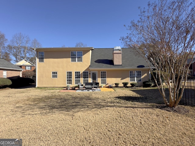 back of house featuring an outdoor living space and a patio