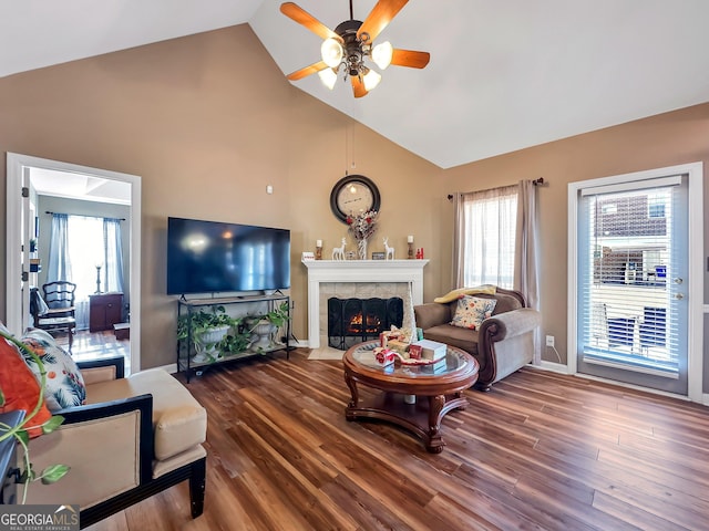 living room with a healthy amount of sunlight, ceiling fan, a fireplace, and wood-type flooring