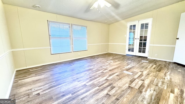 unfurnished room with french doors, a textured ceiling, ceiling fan, and wood-type flooring