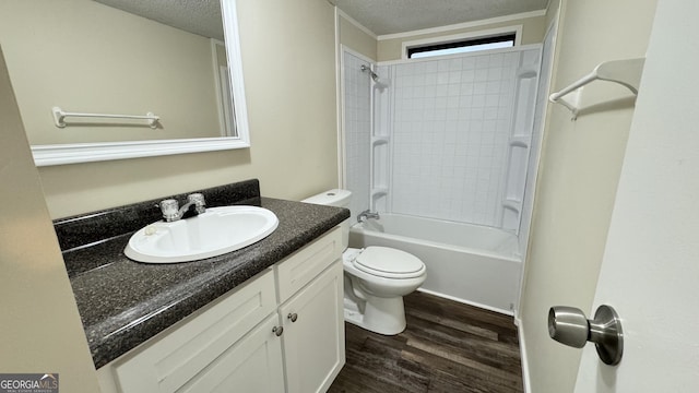 full bathroom with hardwood / wood-style flooring, vanity, shower / bath combination, and a textured ceiling