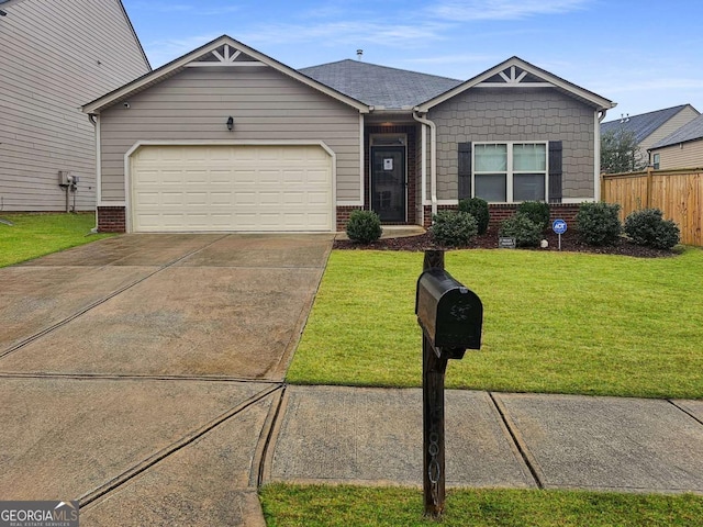 view of front of property featuring a front lawn and a garage