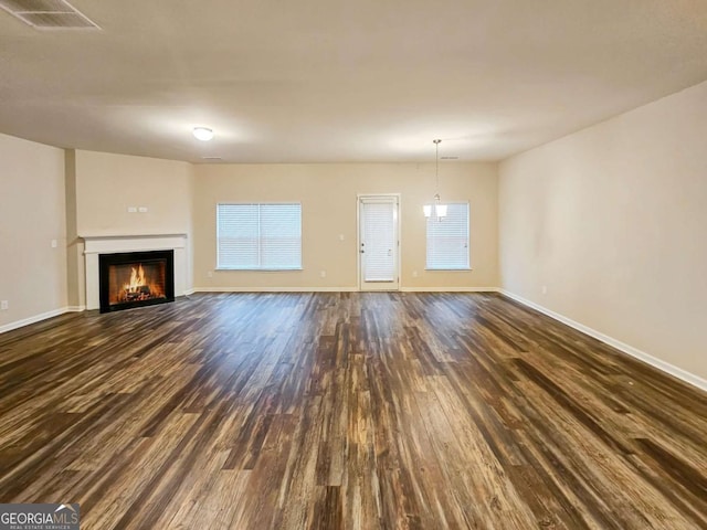 unfurnished living room featuring dark hardwood / wood-style floors