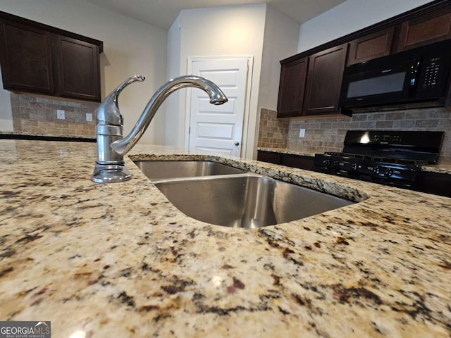 kitchen with decorative backsplash, dark brown cabinetry, light stone countertops, and black appliances