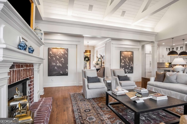 living room featuring dark wood-type flooring, a brick fireplace, wood ceiling, and lofted ceiling with beams