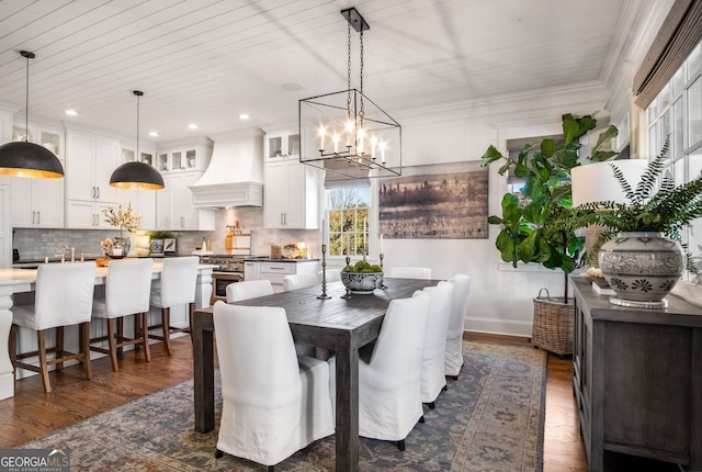 dining area featuring dark hardwood / wood-style flooring, sink, and a notable chandelier