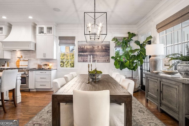 dining space with dark hardwood / wood-style flooring and a chandelier