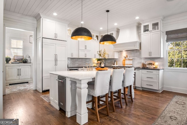 kitchen featuring dark hardwood / wood-style floors, premium range hood, hanging light fixtures, wood ceiling, and white cabinets