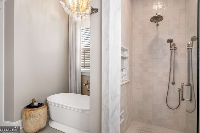 bathroom with a chandelier and separate shower and tub