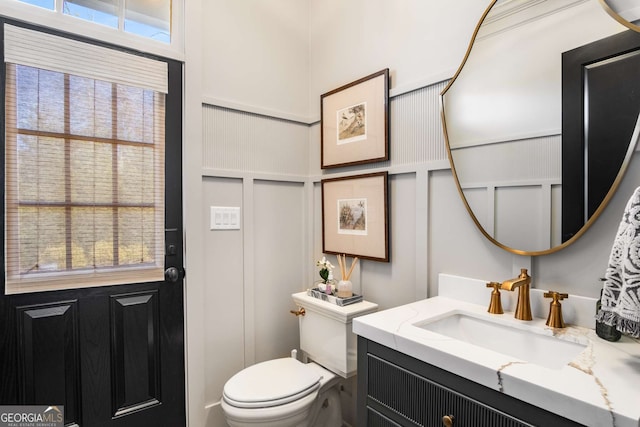 bathroom featuring toilet and vanity