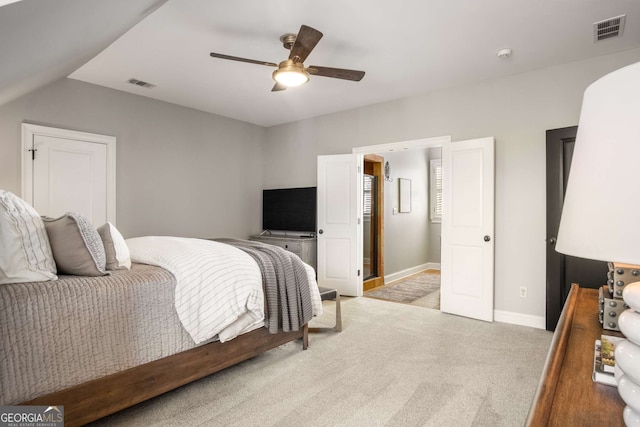 bedroom featuring ceiling fan, light colored carpet, and lofted ceiling