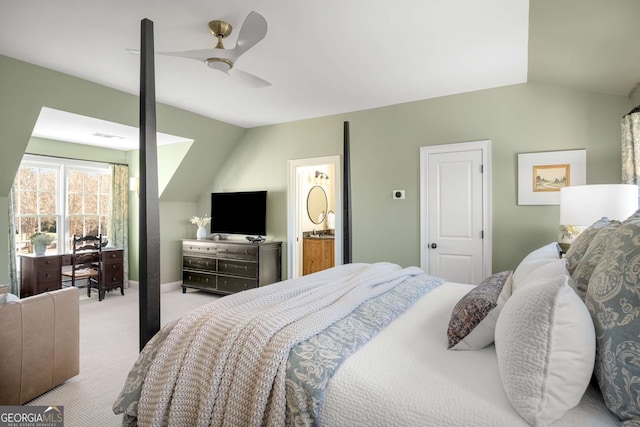 carpeted bedroom featuring ceiling fan, connected bathroom, and lofted ceiling