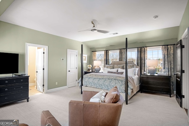 carpeted bedroom with vaulted ceiling, ceiling fan, connected bathroom, and multiple windows