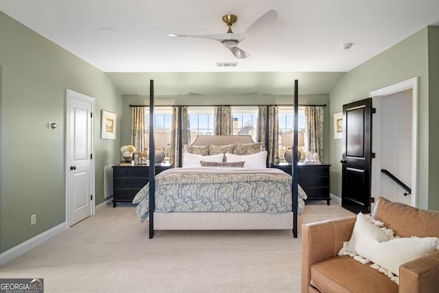 bedroom with ceiling fan, vaulted ceiling, and light carpet