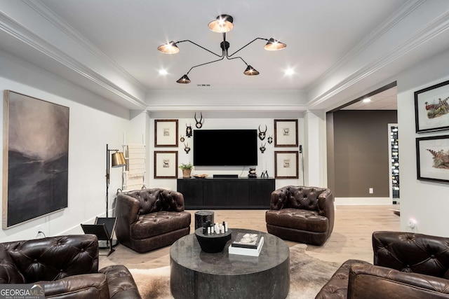 living room featuring wood-type flooring, crown molding, and a chandelier