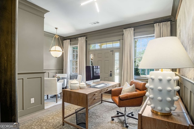 interior space featuring light hardwood / wood-style floors, a wealth of natural light, and crown molding