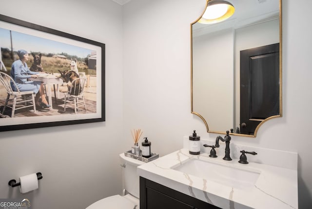 bathroom featuring toilet and vanity