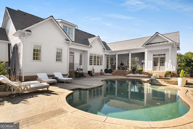 back of property featuring french doors and a patio