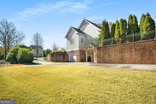 view of property exterior featuring a lawn and a garage