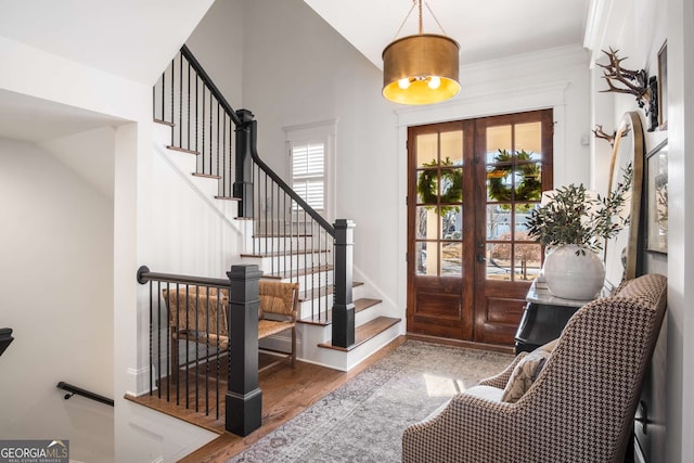 foyer featuring lofted ceiling, french doors, and hardwood / wood-style floors