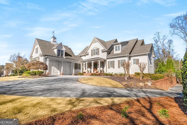 view of front of home featuring a garage and a porch