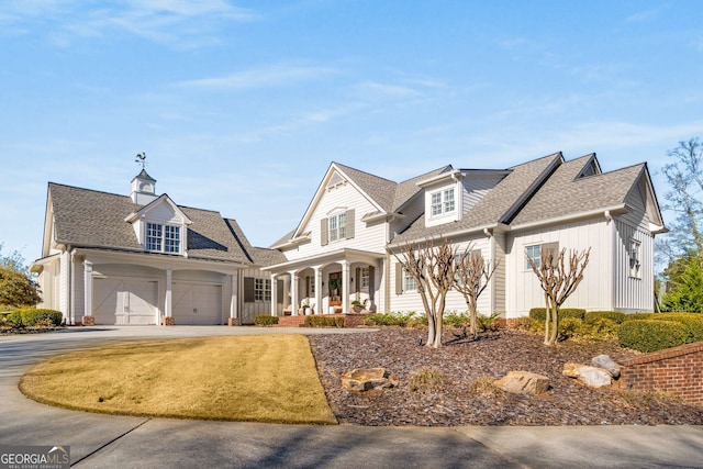 cape cod home with a porch and a garage