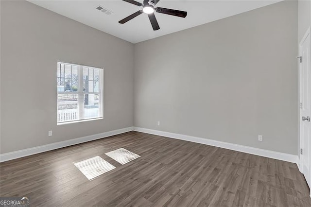 spare room featuring ceiling fan and dark hardwood / wood-style flooring